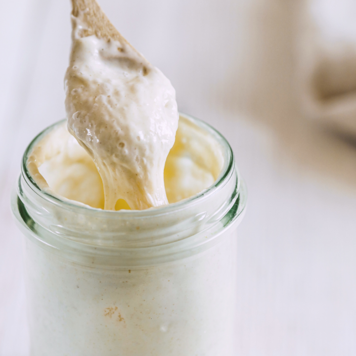 photo of sourdough starter in jar and on spoon