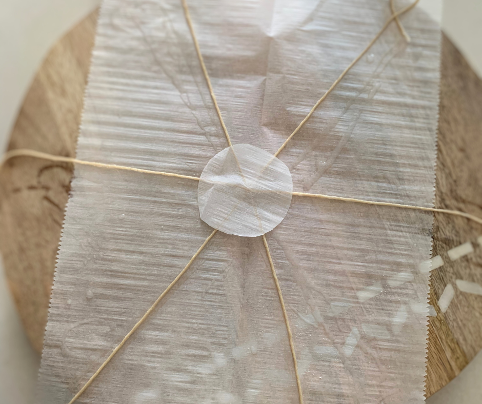 photo of twine and parchment paper laid out to make a pumpkin